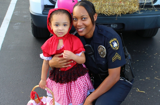 child trick or treating with police officer